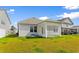 A well-maintained backyard featuring a covered patio, perfect for outdoor relaxation at 490 Calhoun Falls Dr., Myrtle Beach, SC 29579