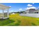 Expansive backyard featuring a white fence, lake view, and a charming screened-in porch at 490 Calhoun Falls Dr., Myrtle Beach, SC 29579