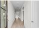 Long hallway with light wood floors and white walls, leading to various rooms at 490 Calhoun Falls Dr., Myrtle Beach, SC 29579