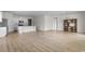 Open floor plan with bright living space featuring wood floors, kitchen with granite countertops, and stainless steel appliances at 490 Calhoun Falls Dr., Myrtle Beach, SC 29579