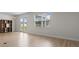 Bright living room with wood floor, modern lighting, and French doors offering view of outdoor space at 490 Calhoun Falls Dr., Myrtle Beach, SC 29579