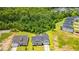 Aerial view of a suburban home with expansive green lawns and lush tree coverage at 5004 Shore Breeze Dr., Myrtle Beach, SC 29588