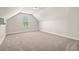 Attic bonus room with plush carpeting and bright window at 5004 Shore Breeze Dr., Myrtle Beach, SC 29588