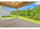 Covered back porch with wood ceiling and ceiling fan, perfect for outdoor entertaining at 5004 Shore Breeze Dr., Myrtle Beach, SC 29588