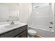 Bright bathroom with a white shower-tub, modern sink, and a window providing natural light at 5004 Shore Breeze Dr., Myrtle Beach, SC 29588
