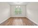 Well-lit dining room features wood flooring, a chandelier, and a large window at 5004 Shore Breeze Dr., Myrtle Beach, SC 29588