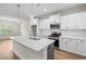 Modern kitchen features pendant lights, white cabinets, stainless steel appliances, and quartz countertops at 5004 Shore Breeze Dr., Myrtle Beach, SC 29588