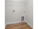 A utilitarian laundry room space with essential utility connections and a sturdy wire rack above at 5004 Shore Breeze Dr., Myrtle Beach, SC 29588