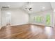 Bright living room with high ceilings, ceiling fan, wood floors, and a patio door at 5004 Shore Breeze Dr., Myrtle Beach, SC 29588