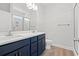 Bathroom with double vanity, framed mirror, and tiled walk-in shower at 5009 Shore Breeze Dr., Myrtle Beach, SC 29588