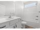 Bright bathroom features a white vanity, toilet, and bathtub with shower, complemented by wood-look flooring at 5009 Shore Breeze Dr., Myrtle Beach, SC 29588