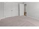 Bedroom featuring a double closet with neutral walls and carpeted floor and view of hall at 5009 Shore Breeze Dr., Myrtle Beach, SC 29588