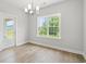 The cozy dining room has luxury vinyl plank flooring, a modern chandelier, and a picturesque backyard view at 5009 Shore Breeze Dr., Myrtle Beach, SC 29588