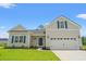 Charming single-Gathering home featuring a two-car garage, craftsman-style design and a well-maintained front lawn at 5009 Shore Breeze Dr., Myrtle Beach, SC 29588