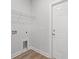 Clean laundry area with hookups, shelving, and door to outside with tile flooring at 5009 Shore Breeze Dr., Myrtle Beach, SC 29588