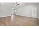 Spacious living room featuring soaring ceilings, natural light, and attractive wood-look flooring at 5009 Shore Breeze Dr., Myrtle Beach, SC 29588