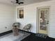 Cozy back porch features rattan furniture and a bright yellow door at 518 Nowell St., Georgetown, SC 29440