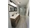 Stylish bathroom featuring double sinks, wood vanity, and a glass-enclosed shower at 518 Nowell St., Georgetown, SC 29440