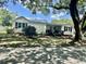 Charming single-story home with white siding, black shutters and a well-manicured front yard at 518 Nowell St., Georgetown, SC 29440