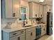 Well-lit kitchen with stainless steel appliances, quartz countertops, and stylish cabinets at 518 Nowell St., Georgetown, SC 29440