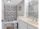 Bathroom with themed wallpaper, white vanity, and a shower-tub combination at 5515 N Ocean Blvd. # 209, Myrtle Beach, SC 29577