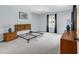 Bright bedroom featuring neutral carpet, light blue walls, and natural wood furniture at 5515 N Ocean Blvd. # 209, Myrtle Beach, SC 29577