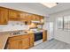 Functional kitchen with wooden cabinets, white appliances, and ample counter space at 5515 N Ocean Blvd. # 209, Myrtle Beach, SC 29577