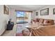 Bright living room with neutral decor, balcony access overlooking the community pool at 5515 N Ocean Blvd. # 209, Myrtle Beach, SC 29577