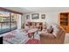 Open-concept living room featuring balcony access and views of the neighborhood at 5515 N Ocean Blvd. # 209, Myrtle Beach, SC 29577