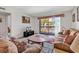 Cozy living room with comfortable seating, view of the community pool and balcony access at 5515 N Ocean Blvd. # 209, Myrtle Beach, SC 29577