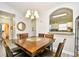 Dining room with wood table, seating for six, chandelier, and opening to kitchen at 5825 Catalina Dr. # 833, North Myrtle Beach, SC 29582