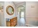 Welcoming hallway with decorative mirror and stylish furnishings, leading to a bright doorway at 5825 Catalina Dr. # 833, North Myrtle Beach, SC 29582