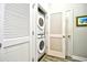 A well-organized laundry area featuring a stacked washer and dryer behind louvered doors at 5825 Catalina Dr. # 833, North Myrtle Beach, SC 29582