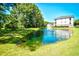 Scenic view of a pond with fountain, surrounded by lush greenery and a beautiful condo building at 5825 Catalina Dr. # 833, North Myrtle Beach, SC 29582