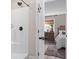 Bright bathroom featuring a walk-in shower, dark fixtures, and a glimpse into the bedroom at 589 Boundaryline Dr. Nw, Calabash, NC 28467