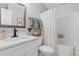 Well-lit bathroom with a vanity, toilet, and shower-tub combo at 589 Boundaryline Dr. Nw, Calabash, NC 28467