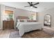 Sun-filled bedroom with neutral tones, stylish ceiling fan, and elegant furnishings at 589 Boundaryline Dr. Nw, Calabash, NC 28467