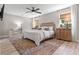 Cozy bedroom with neutral decor, natural window shades, and soft rug over wood floors at 589 Boundaryline Dr. Nw, Calabash, NC 28467