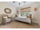 Comfortable bedroom featuring a daybed with many pillows, natural light, and wicker chair at 589 Boundaryline Dr. Nw, Calabash, NC 28467