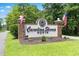 Entrance sign for Carolina Shores North community with brick columns and attractive landscaping at 589 Boundaryline Dr. Nw, Calabash, NC 28467