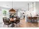 Bright dining area featuring wood table, wicker chairs, and a modern open floor plan to the kitchen at 589 Boundaryline Dr. Nw, Calabash, NC 28467