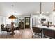 Open-concept dining area with hardwood floors and an open layout with sightlines to the kitchen at 589 Boundaryline Dr. Nw, Calabash, NC 28467