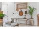 Well-decorated entryway featuring a stylish bench, wall art, and indoor plant at 589 Boundaryline Dr. Nw, Calabash, NC 28467