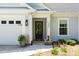 A close-up of the home's entry, showing house number, stylish sidelight, and front door at 589 Boundaryline Dr. Nw, Calabash, NC 28467