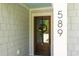 An inviting front door adorned with a wreath welcomes guests into this well-maintained home at 589 Boundaryline Dr. Nw, Calabash, NC 28467