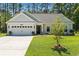 Charming single-story home featuring a two-car garage, well-manicured lawn, and inviting curb appeal at 589 Boundaryline Dr. Nw, Calabash, NC 28467