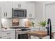 Gourmet kitchen with stainless steel appliances, stone counters, and ample cabinet storage at 589 Boundaryline Dr. Nw, Calabash, NC 28467
