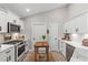 Bright white kitchen boasts modern appliances, crisp white cabinets, and butcher-block island at 589 Boundaryline Dr. Nw, Calabash, NC 28467