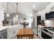 Open concept kitchen featuring an eat-in island and a dining area at 589 Boundaryline Dr. Nw, Calabash, NC 28467