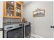 Convenient laundry room featuring modern washer and dryer, cabinet space, and stylish decor at 589 Boundaryline Dr. Nw, Calabash, NC 28467